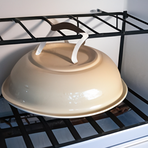 A Dutch oven placed on a dish rack for drying after cleaning.